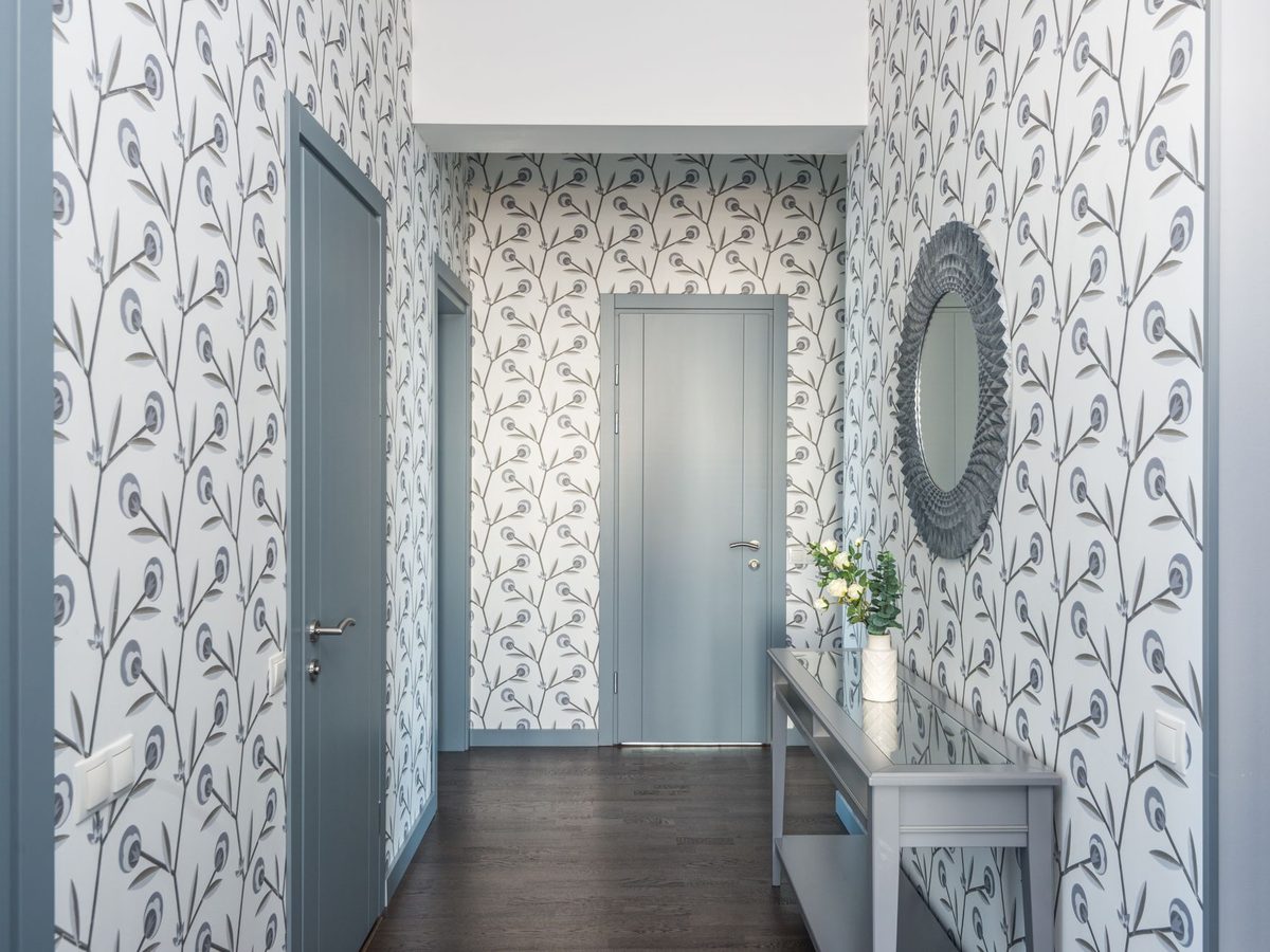 Delicate patterned wallpaper running the length of an elegant entry hallway