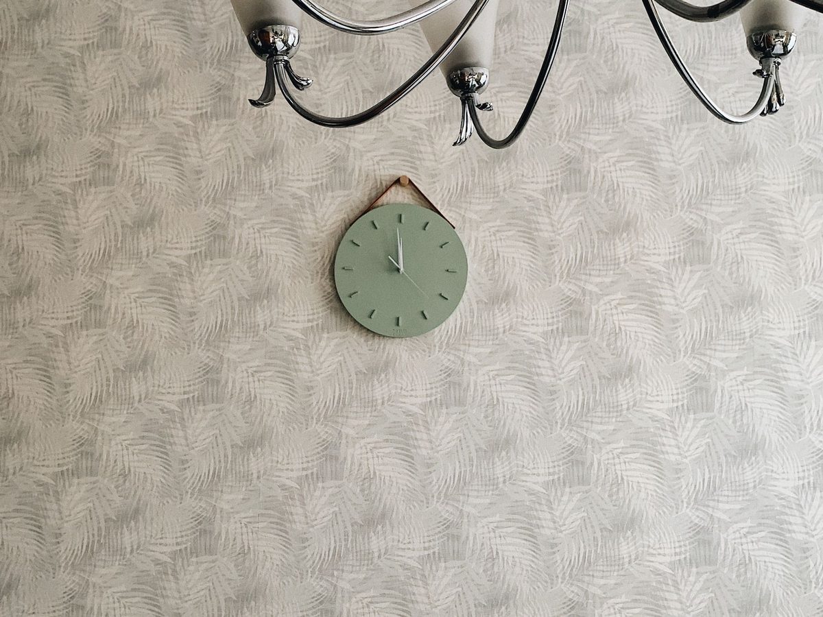 Subtle cream leaf-textured wallpaper on a living room wall